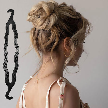 Side angle of the black plastic magic roll bun clip illustrating its sleek and lightweight profile.