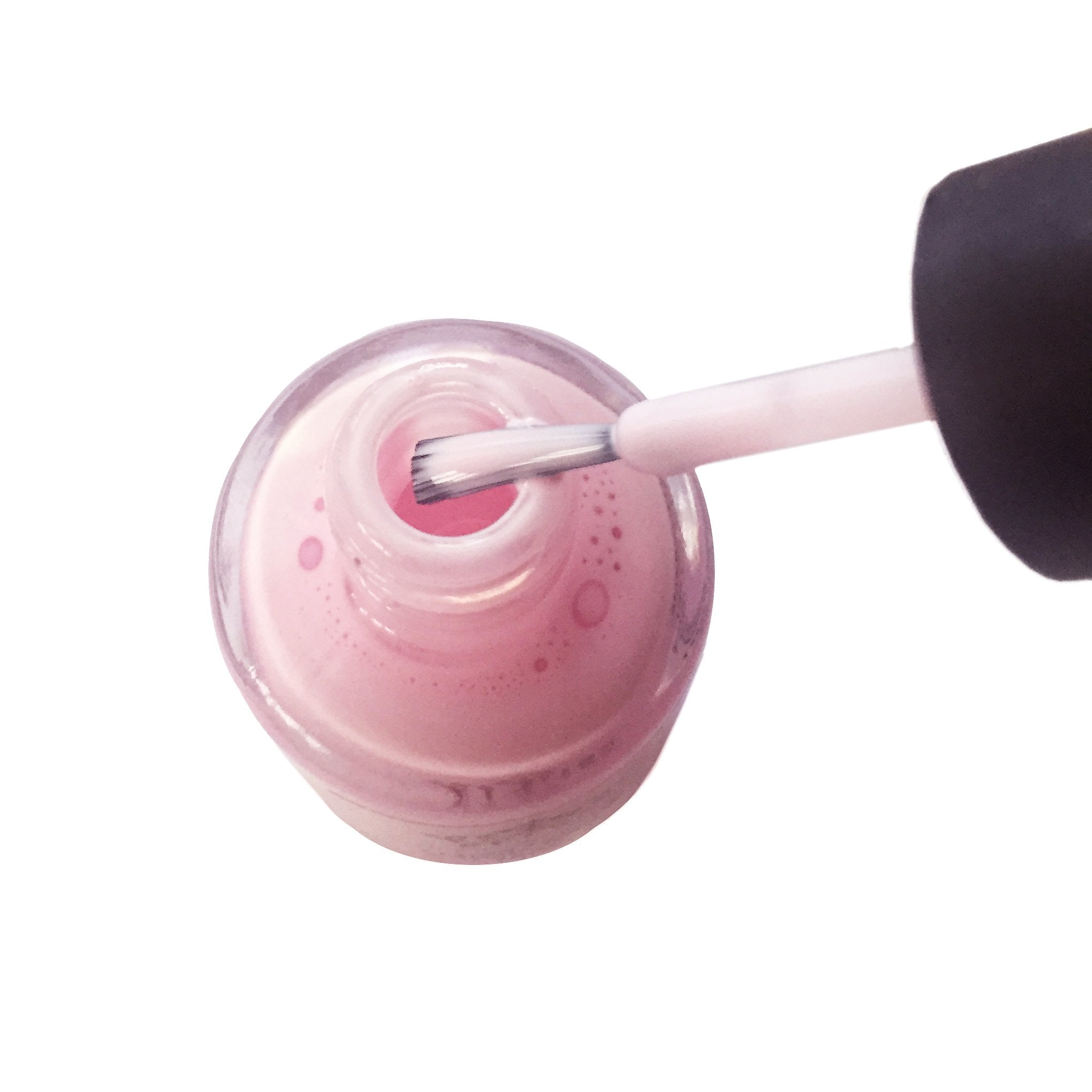 Pueen skin barrier protector drying to a clear pink hue during a home manicure session.