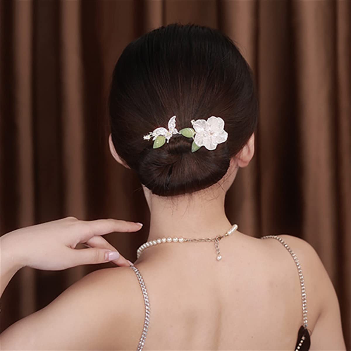 Takeberny flexible hair accessory being rolled up to create a French twist updo