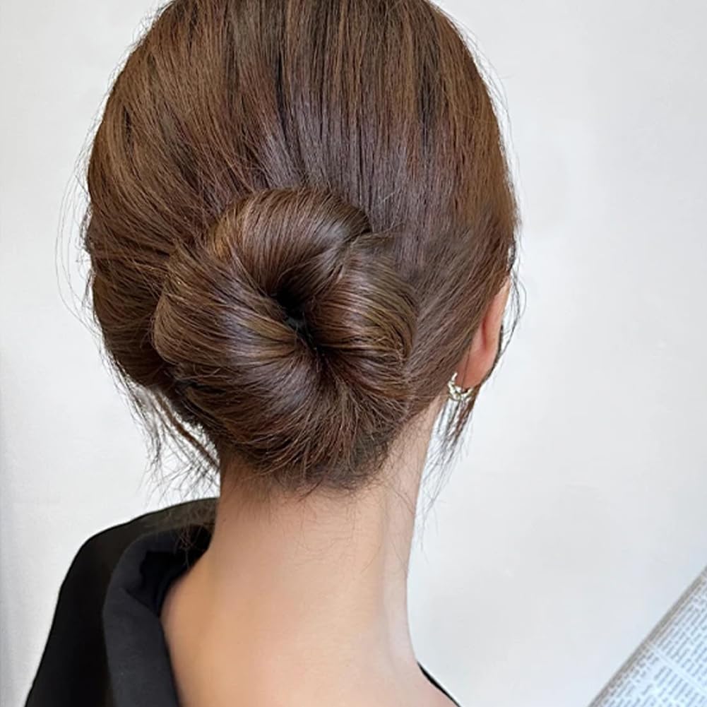 Rear view of sleek ballet bun hairstyle achieved using sponge roller clip