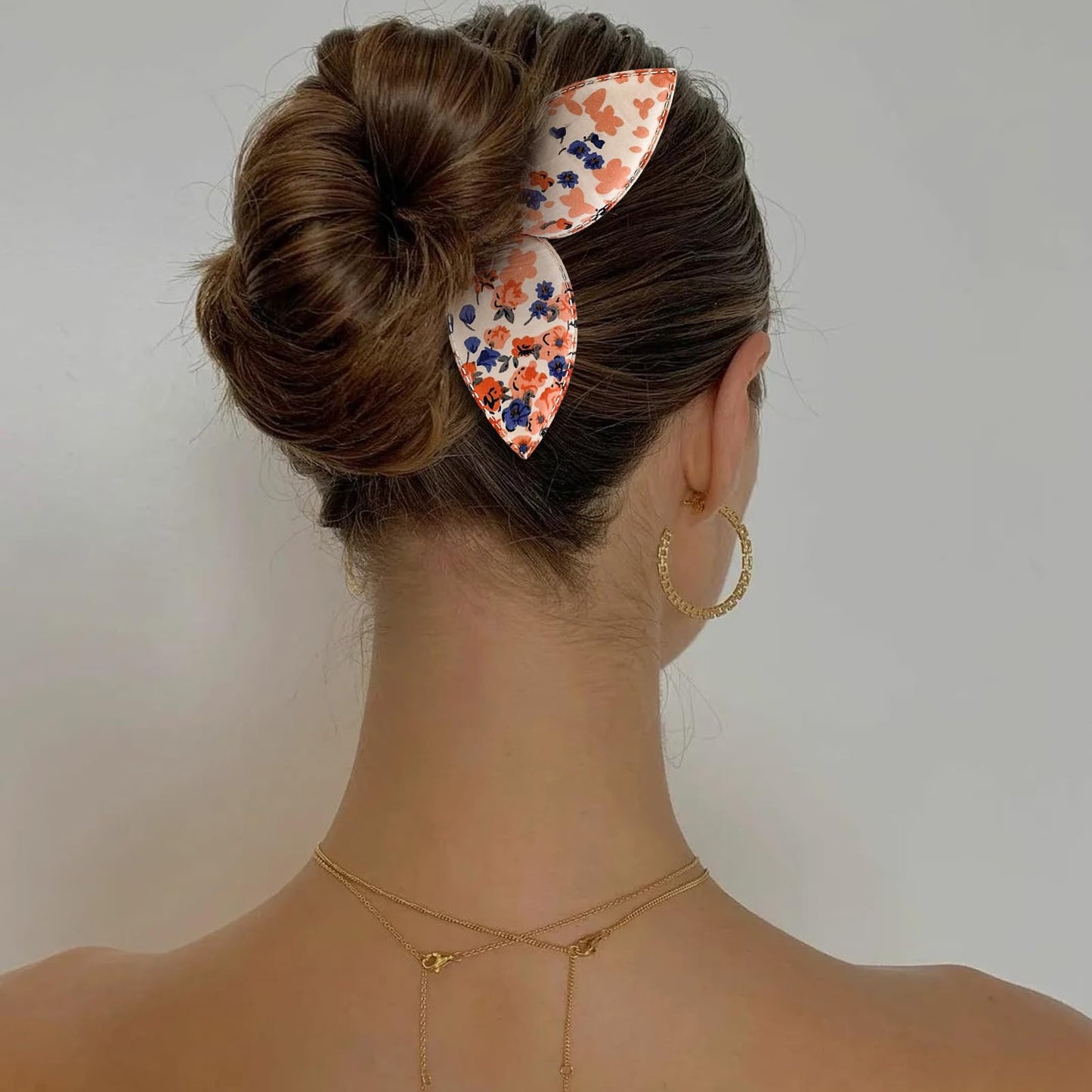 Travel friendly hair styling kit showing four diverse patterns of fabric bun makers.