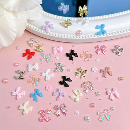 Manicure layout showing 3D bow and butterfly nail charms