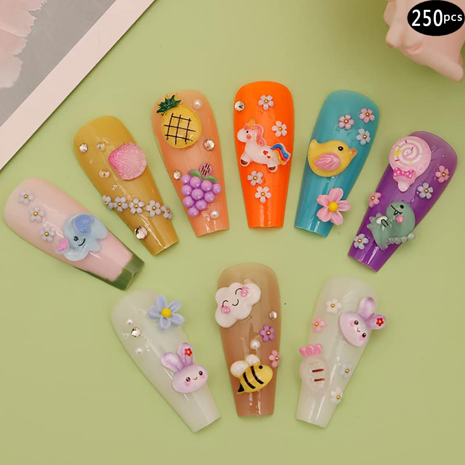 Kawaii style miniature fruit and animal resin decorations arranged neatly for DIY crafting.
