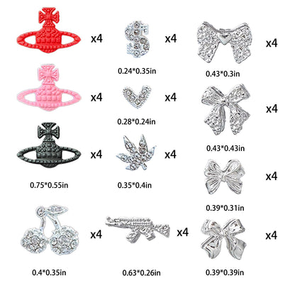 Assorted silver alloy gun and dollar sign nail jewelry pieces laid out flat