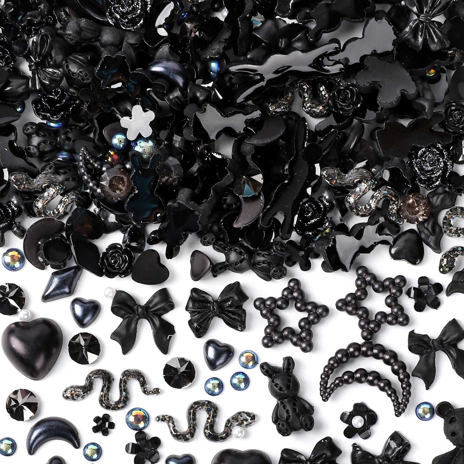 Collection of black themed DIY craft embellishments highlighting detailed textures of moons and roses
