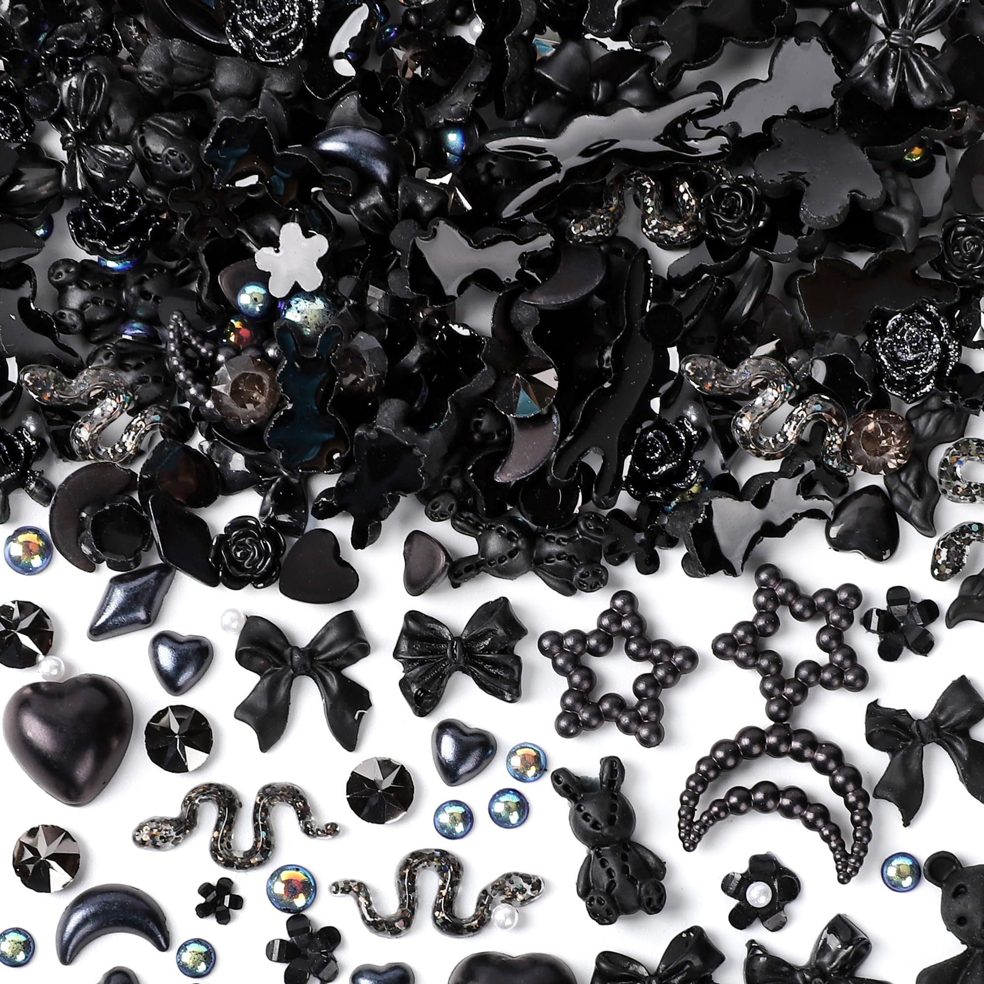 Collection of black themed DIY craft embellishments highlighting detailed textures of moons and roses