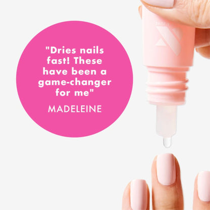 Hand applying Olive and June Dry Drops to polished nails.