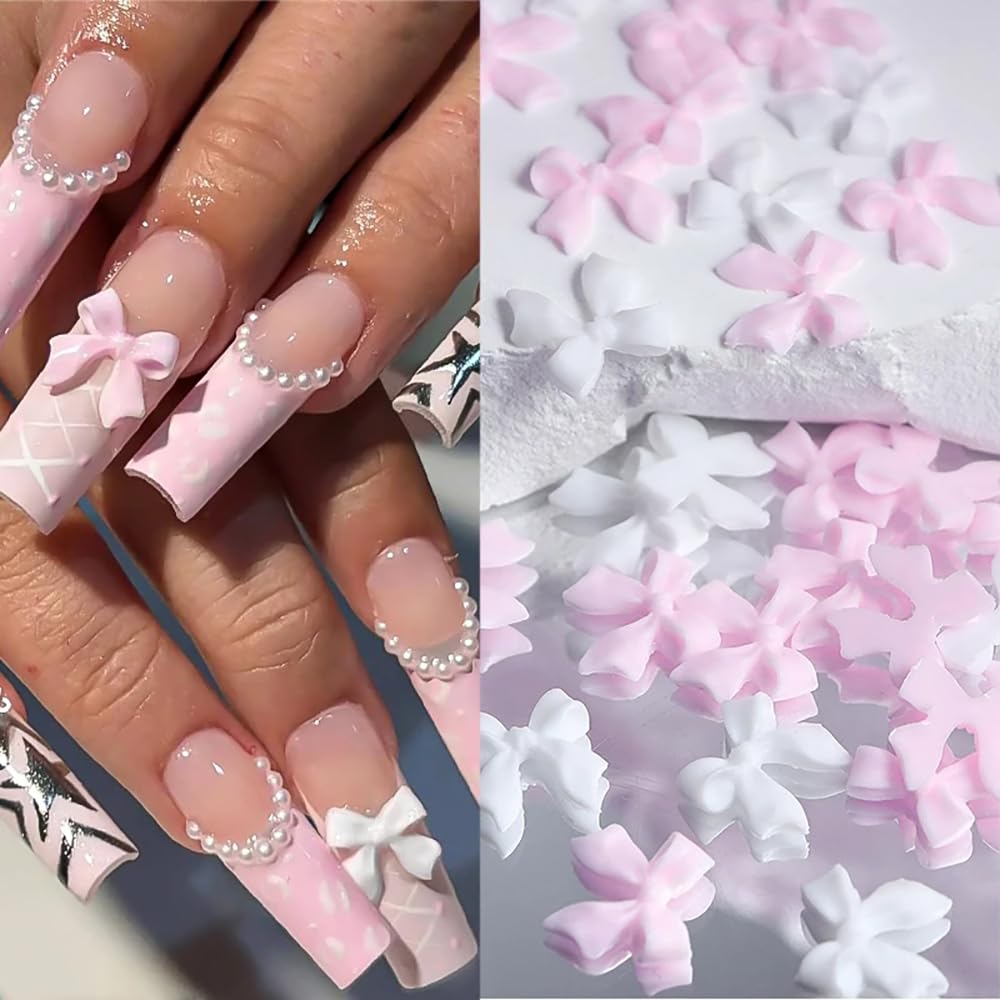 Close up of pink and white acrylic flower nail gems with white half pearls for manicures.
