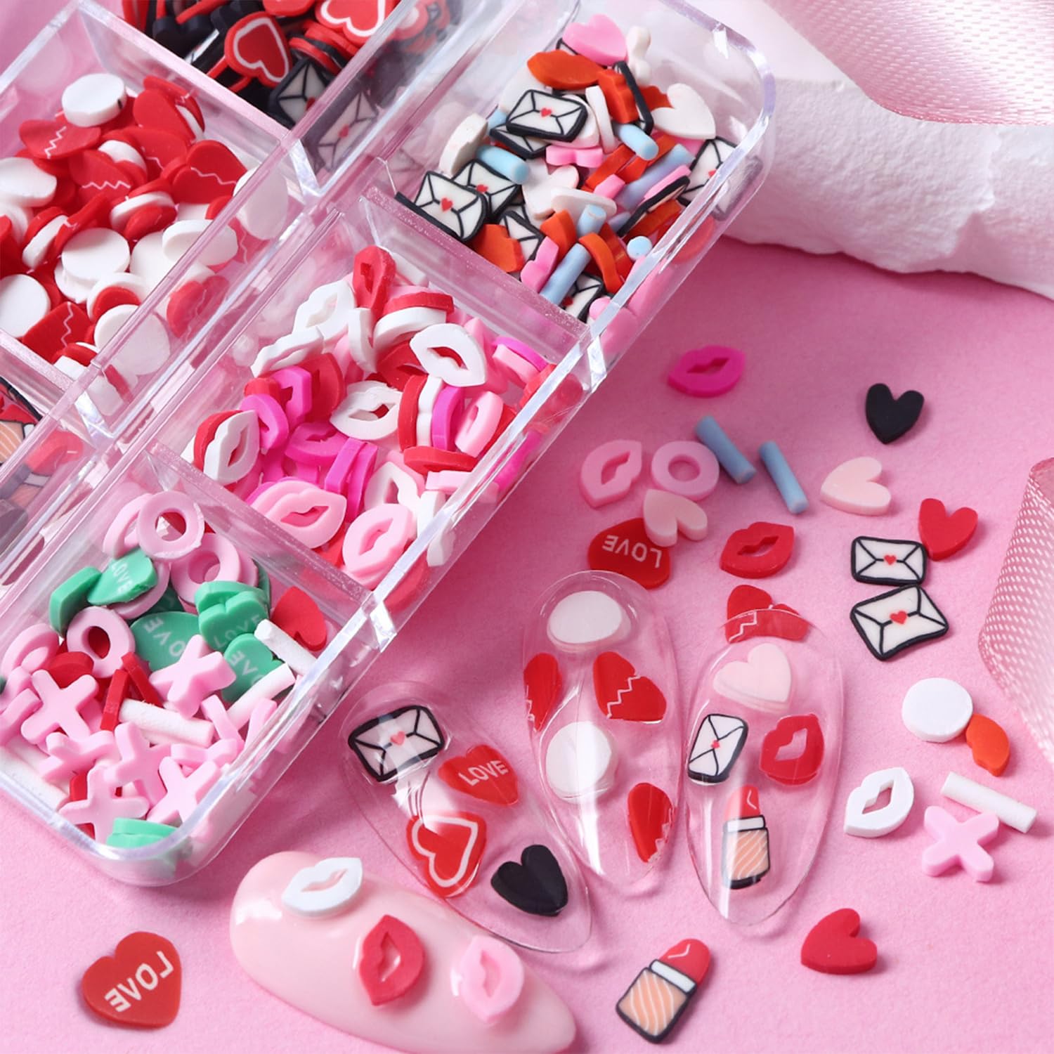 Close up view of multi color polymer clay heart and envelope charms for 3D manicures