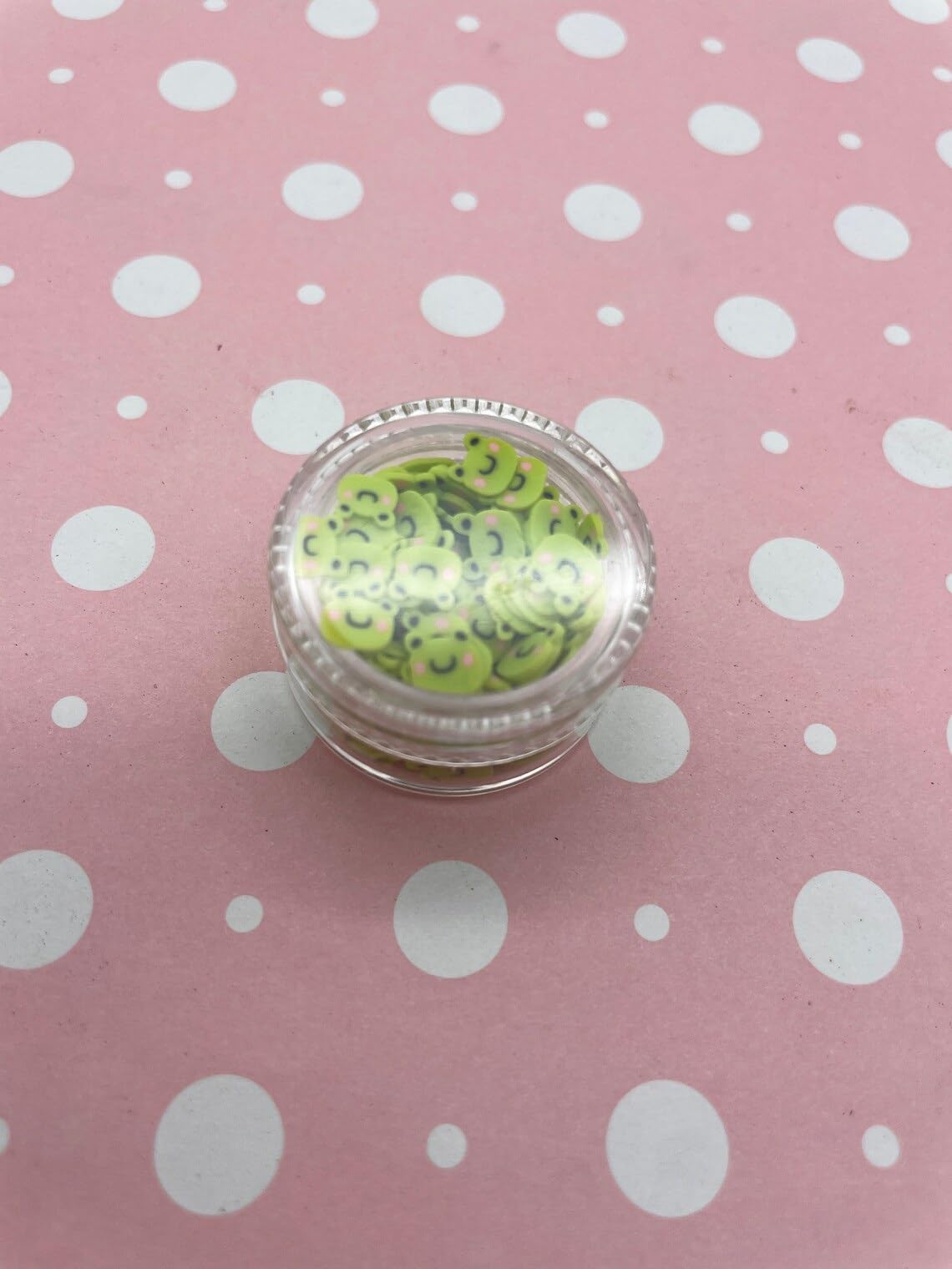 Detailed view of frog shaped polymer clay confetti for crafts