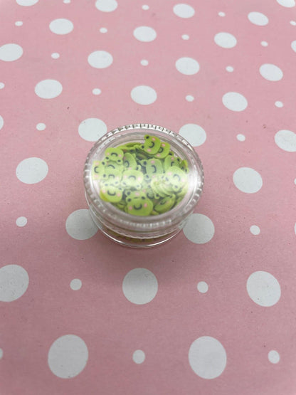 Detailed view of frog shaped polymer clay confetti for crafts