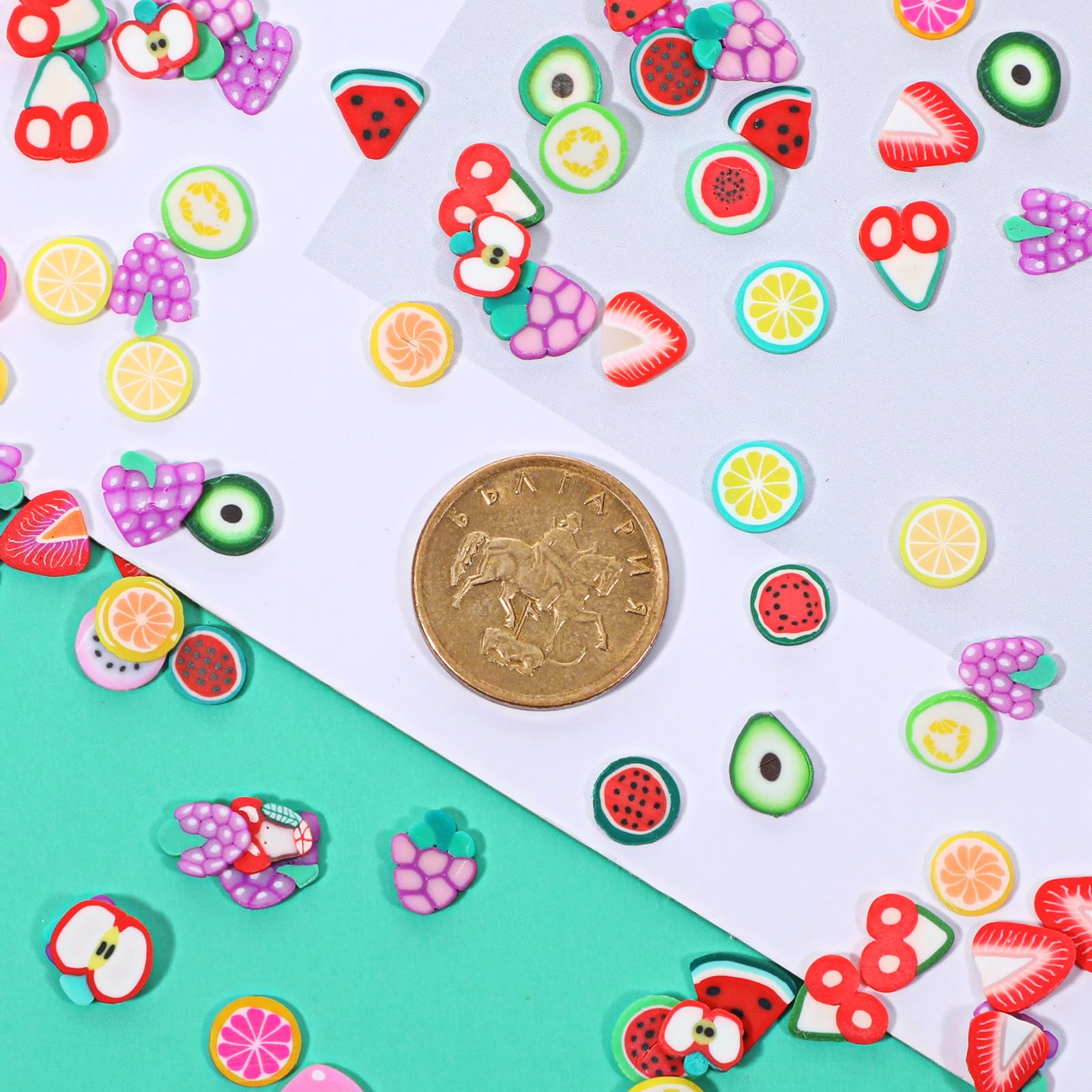 Close up of mixed color fruit nail art charms