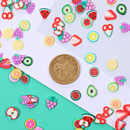 Close up of mixed color fruit nail art charms