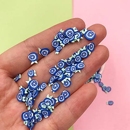 Blue and white fimo fruit slices used as creative accessories for resin and DIY crafts.