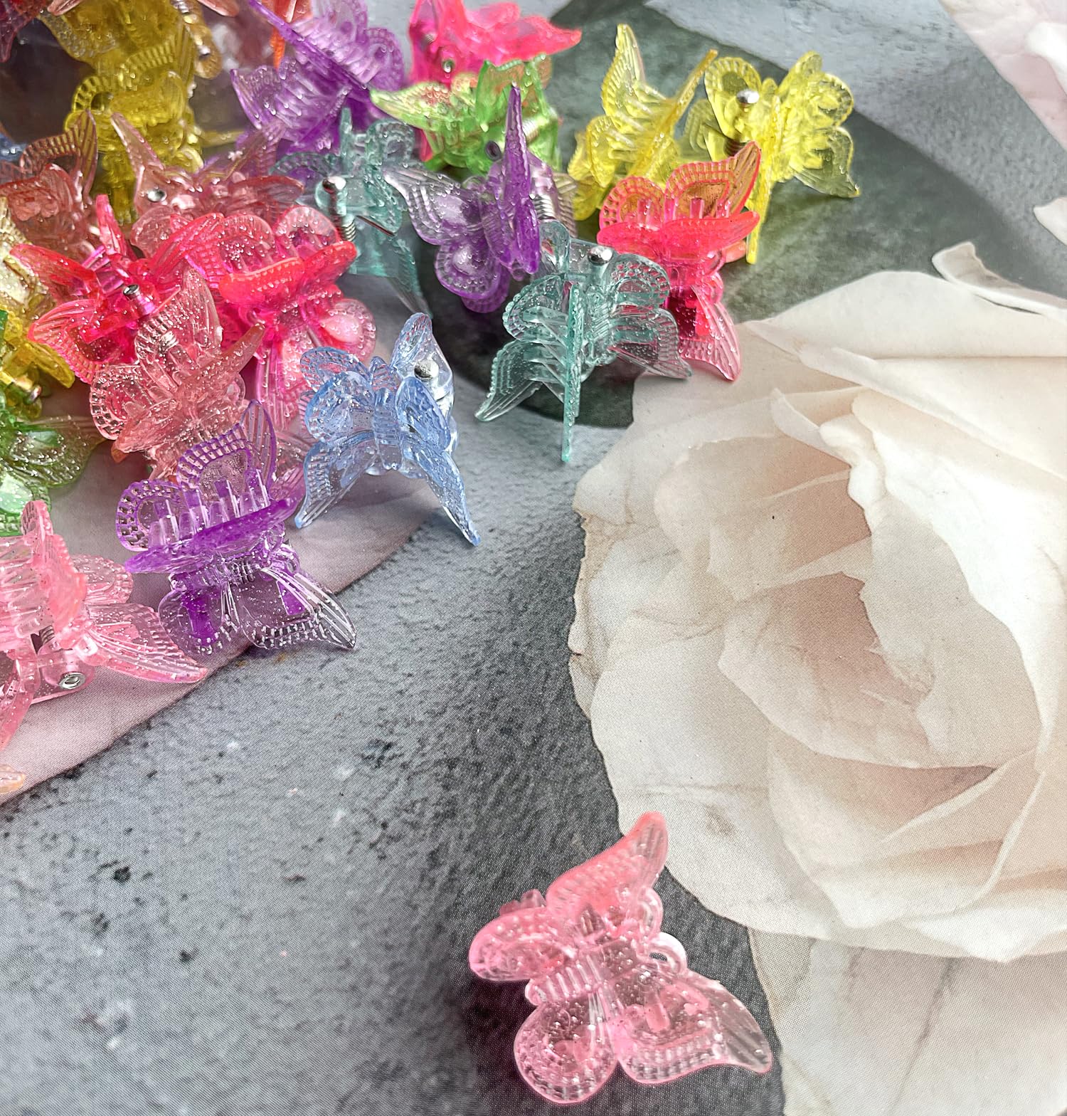 Bebeepoo glitter butterfly clips displayed in plastic container