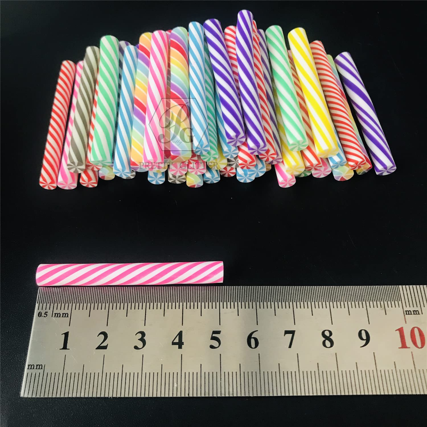 Miniature colorful candy cane slices mixed inside a clear slime kit