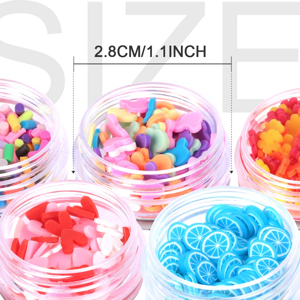 Close up view of miniature polymer clay fimo slices shaped like watermelons kiwis and strawberries for DIY craft decoration