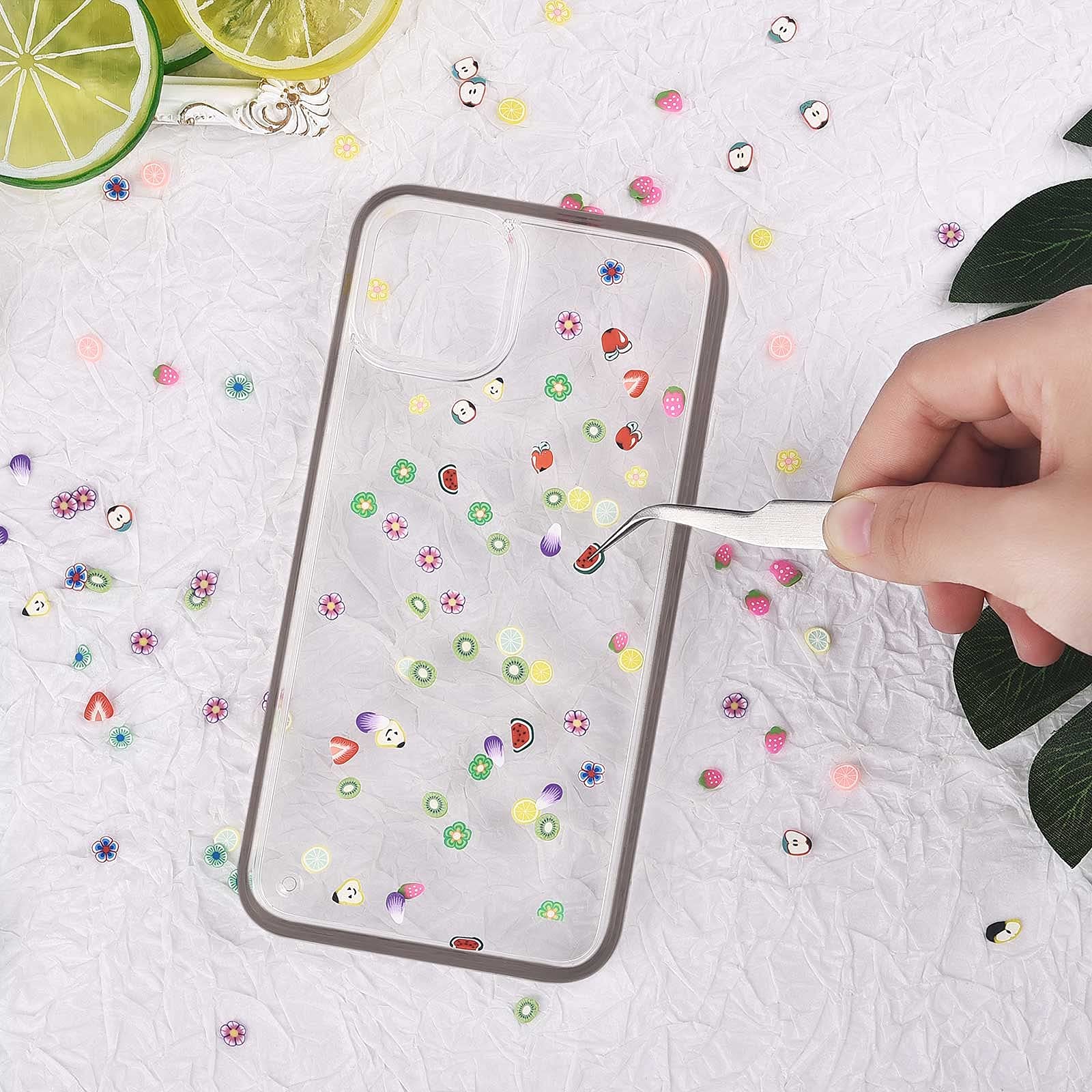 Vibrant 3D miniature fruit slices applied meticulously onto manicured fingernails for summer nail art.