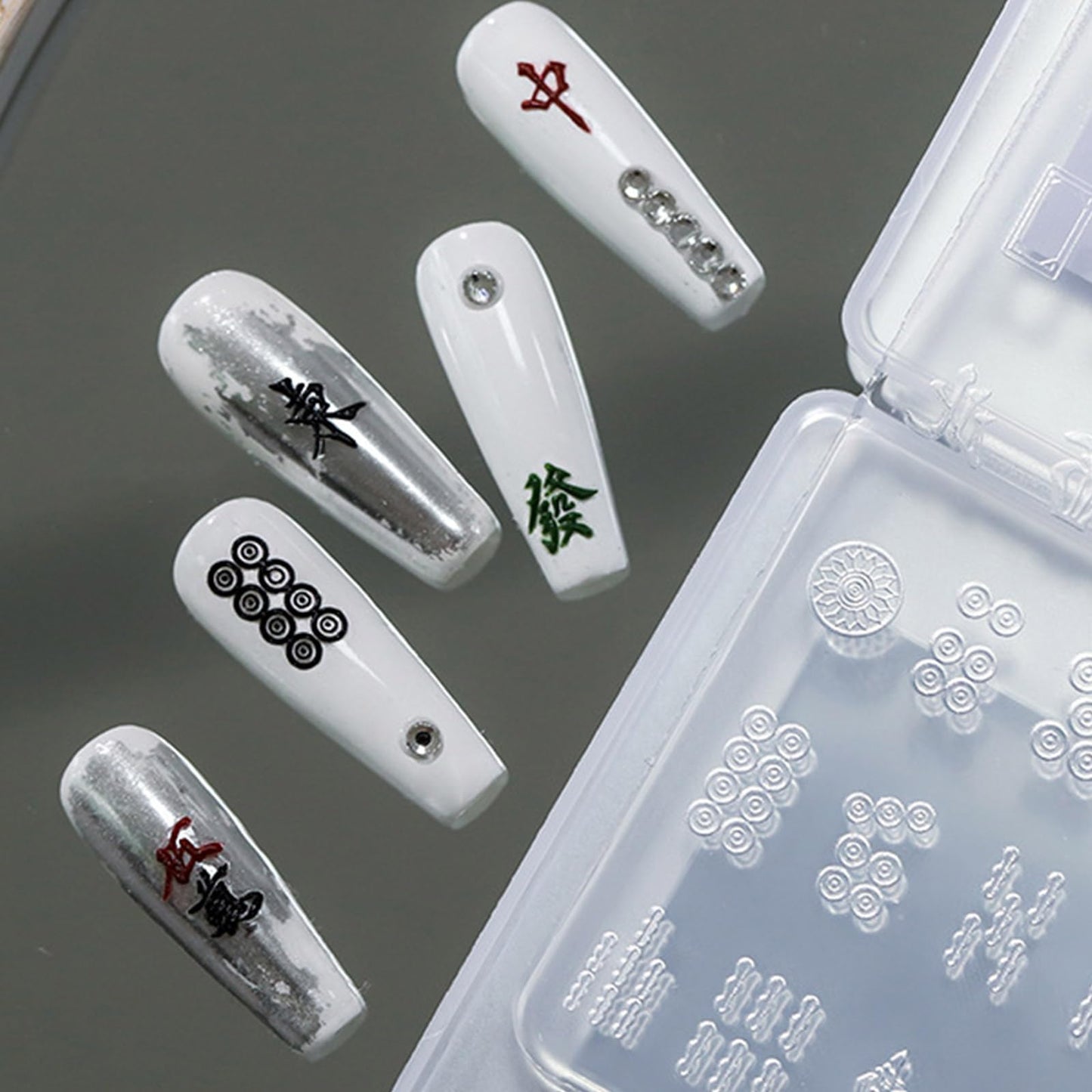 Handheld view of butterfly charm released from silicone mold