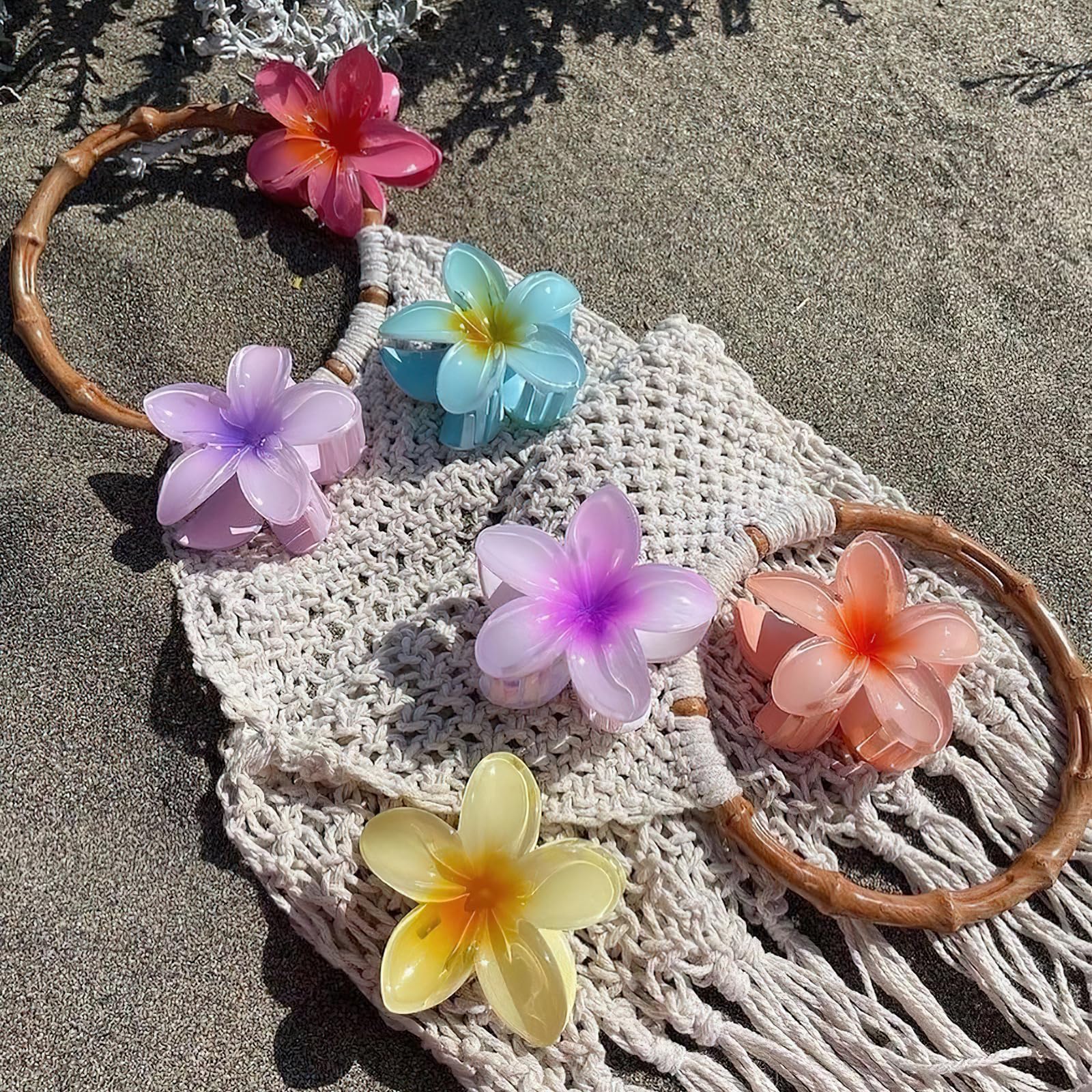 Top down view of four piece flower hair clip set in vibrant colors