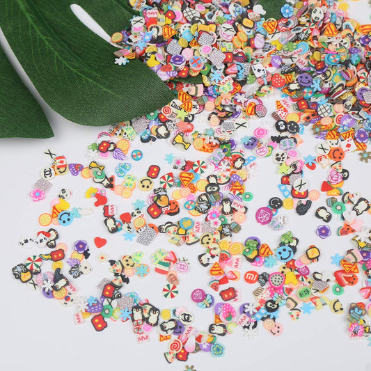 Close up view of diverse fimo clay slice designs including miniature fruits, flowers, and cartoon animals.
