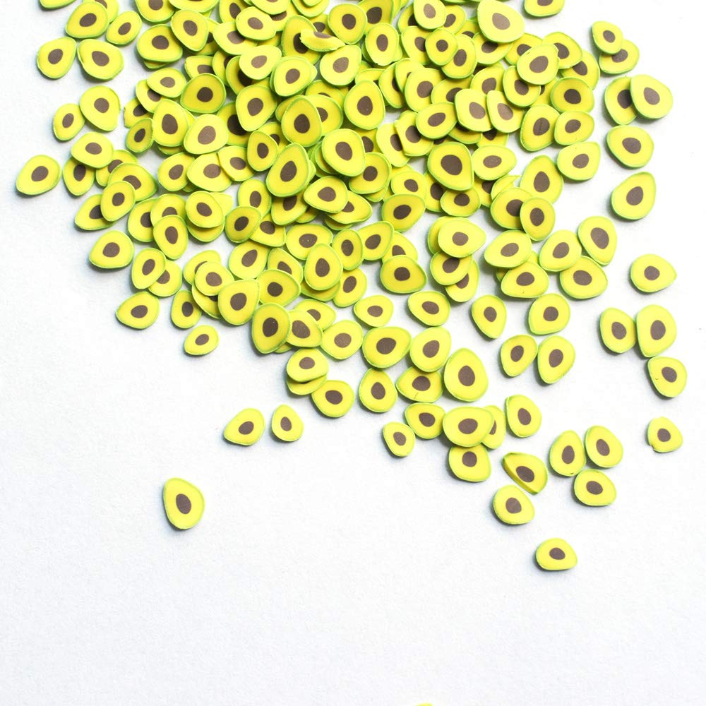 Close up view of tiny green avocado plastic fruit klei mud pieces for nail art and slime making