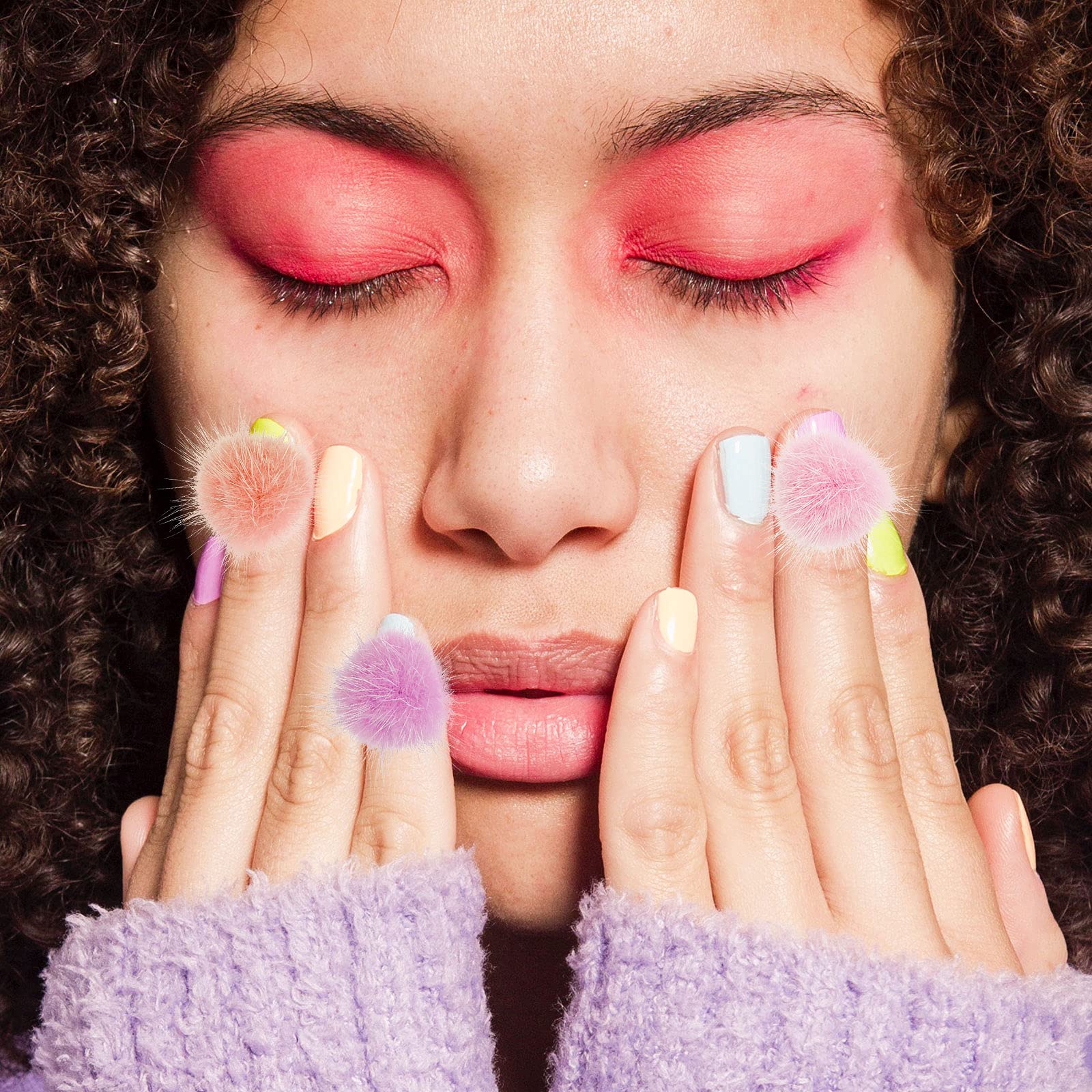 Manicure model displaying a completed 3D nail art design featuring soft pink and white fluffy pompoms.