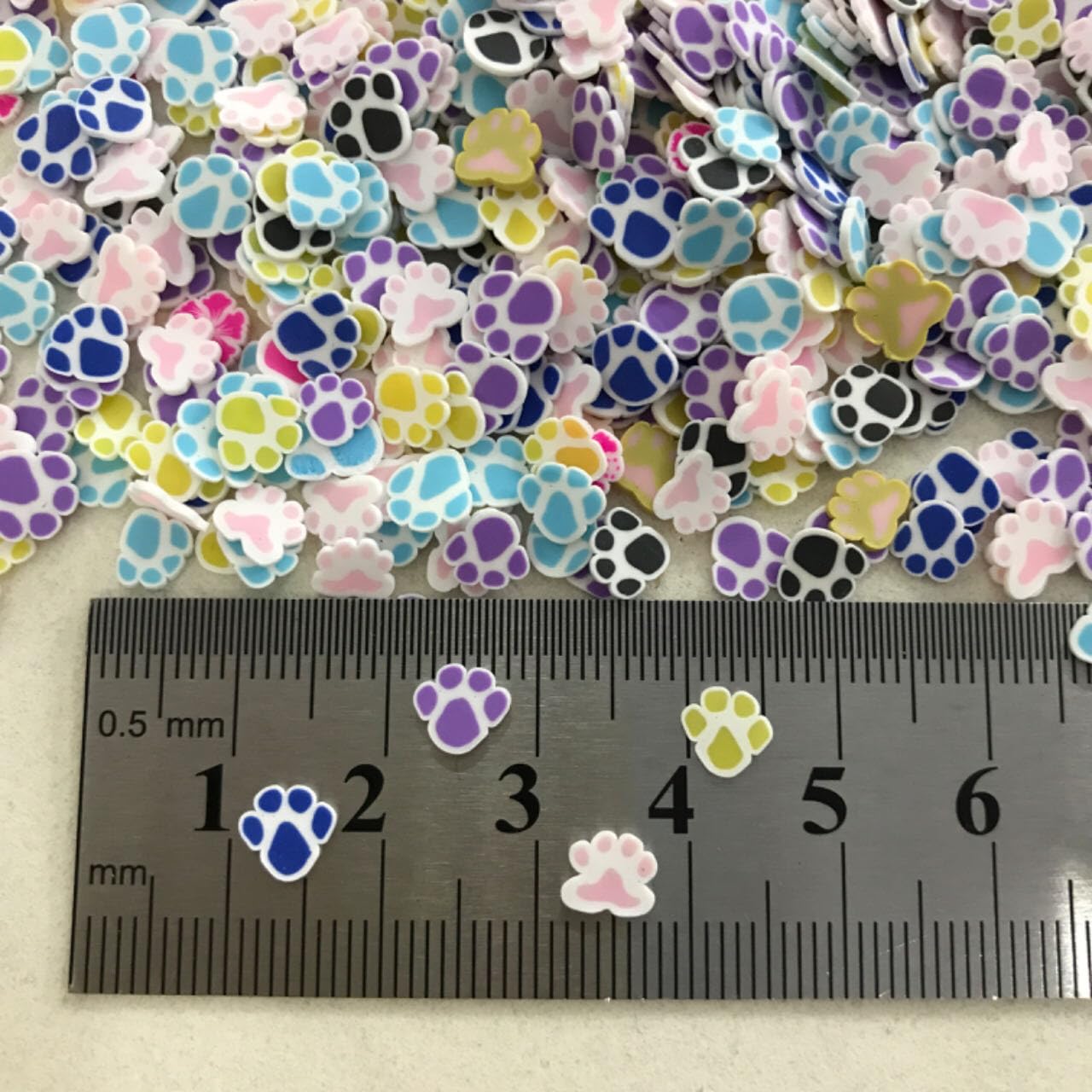 Detailed view of colorful Fimo clay slices mixed inside a clear crafting resin application.