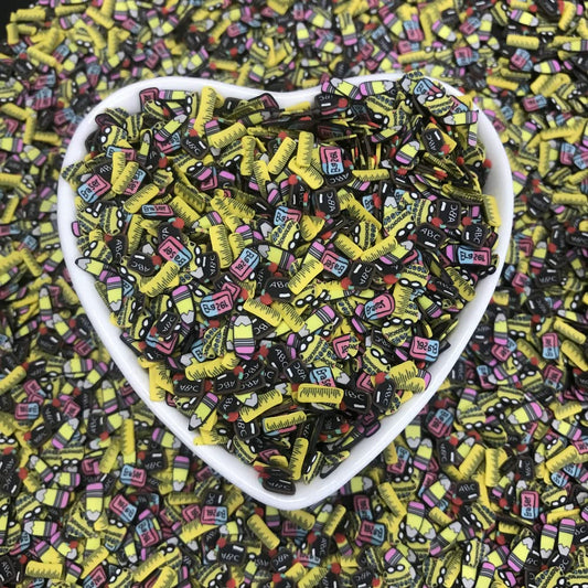 PrettyG Fimo soft clay sprinkles spread out on a flat surface demonstrating the variety of blackboard and ruler shapes.