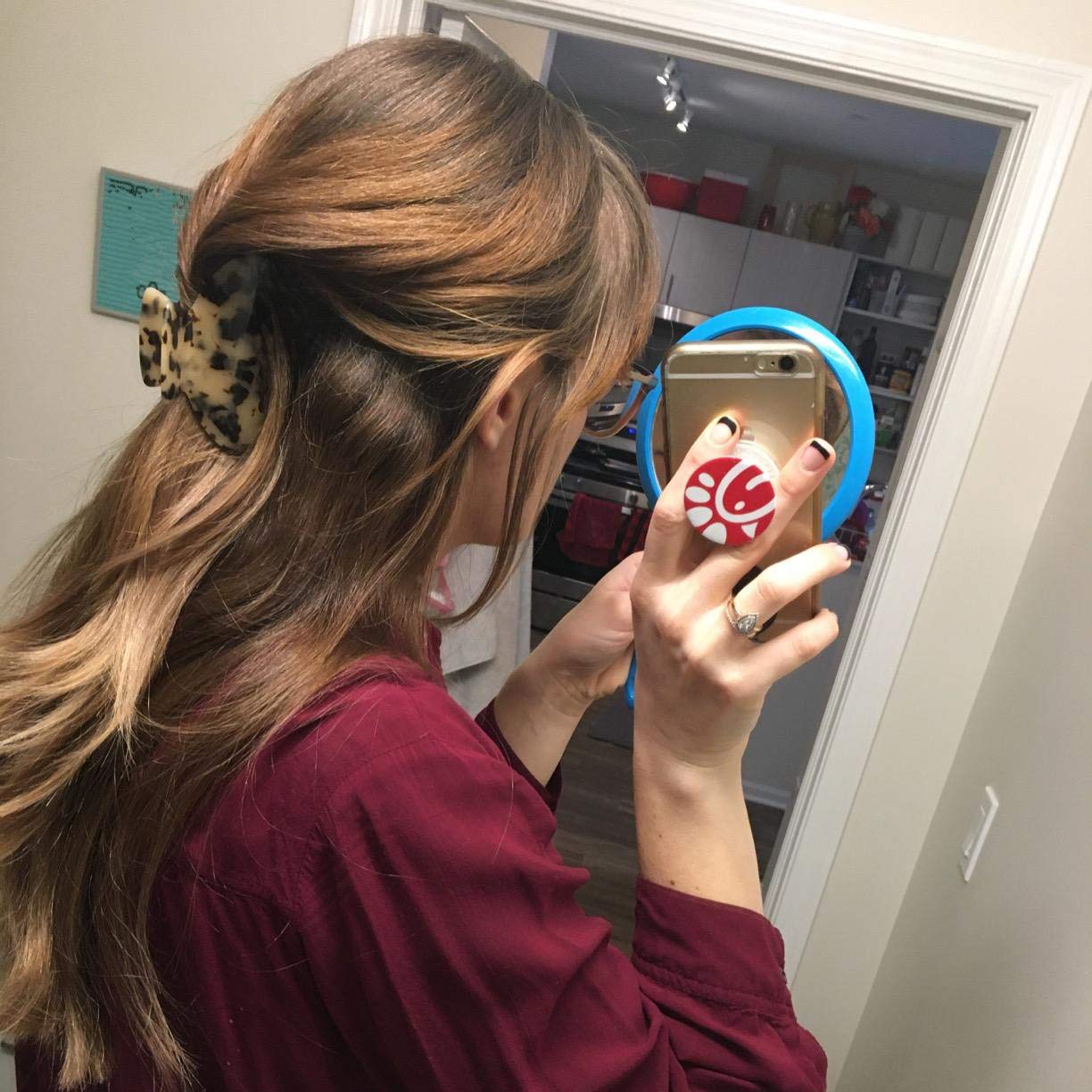 Fsmiling tortoise shell clips holding thick hair in an updo