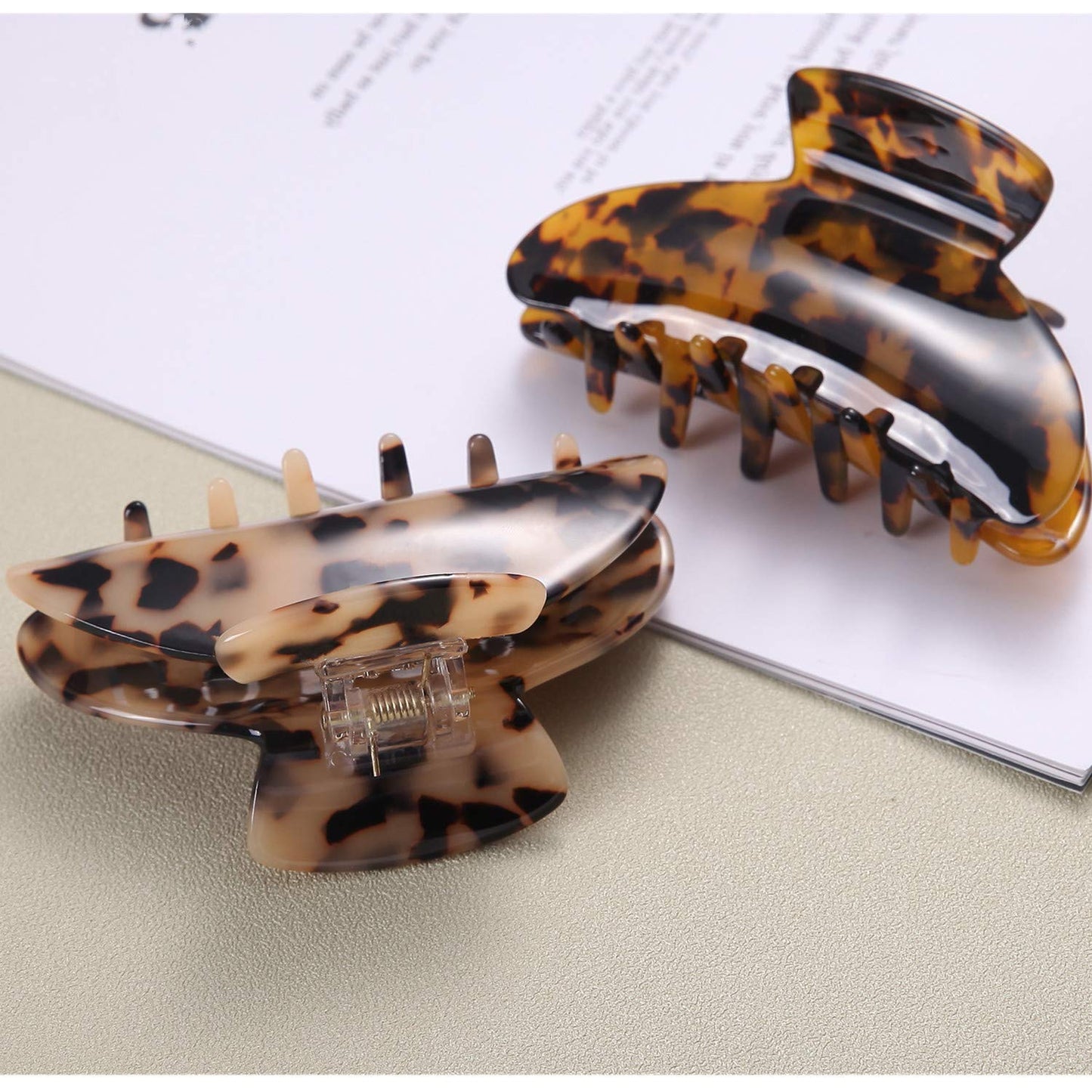 Two Fsmiling claw clips arranged on a flat surface