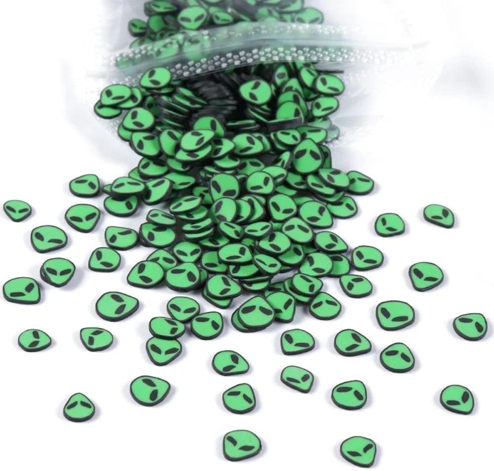 Close up of green alien head clay slices for DIY manicure