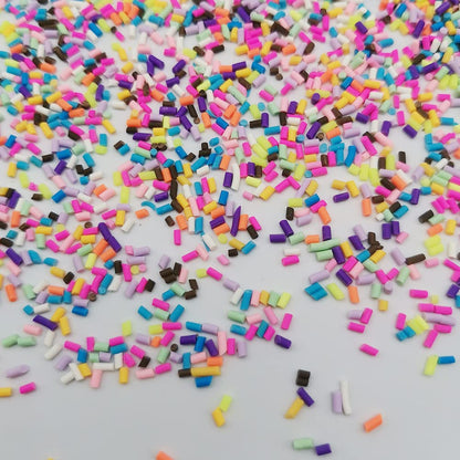 Vibrant polymer clay faux candy slices scattered on a flat surface