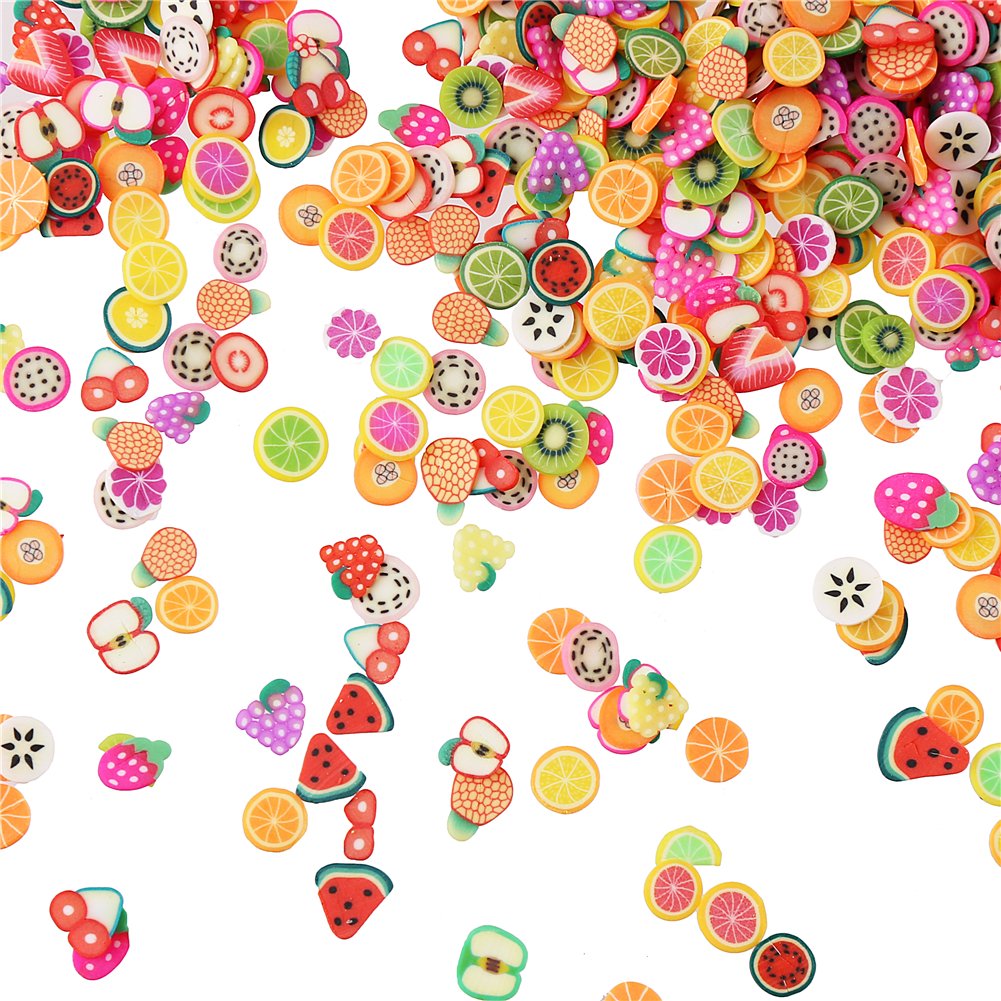 DECORA 3D fruit slices applied neatly on manicured fingernails for summer nail art