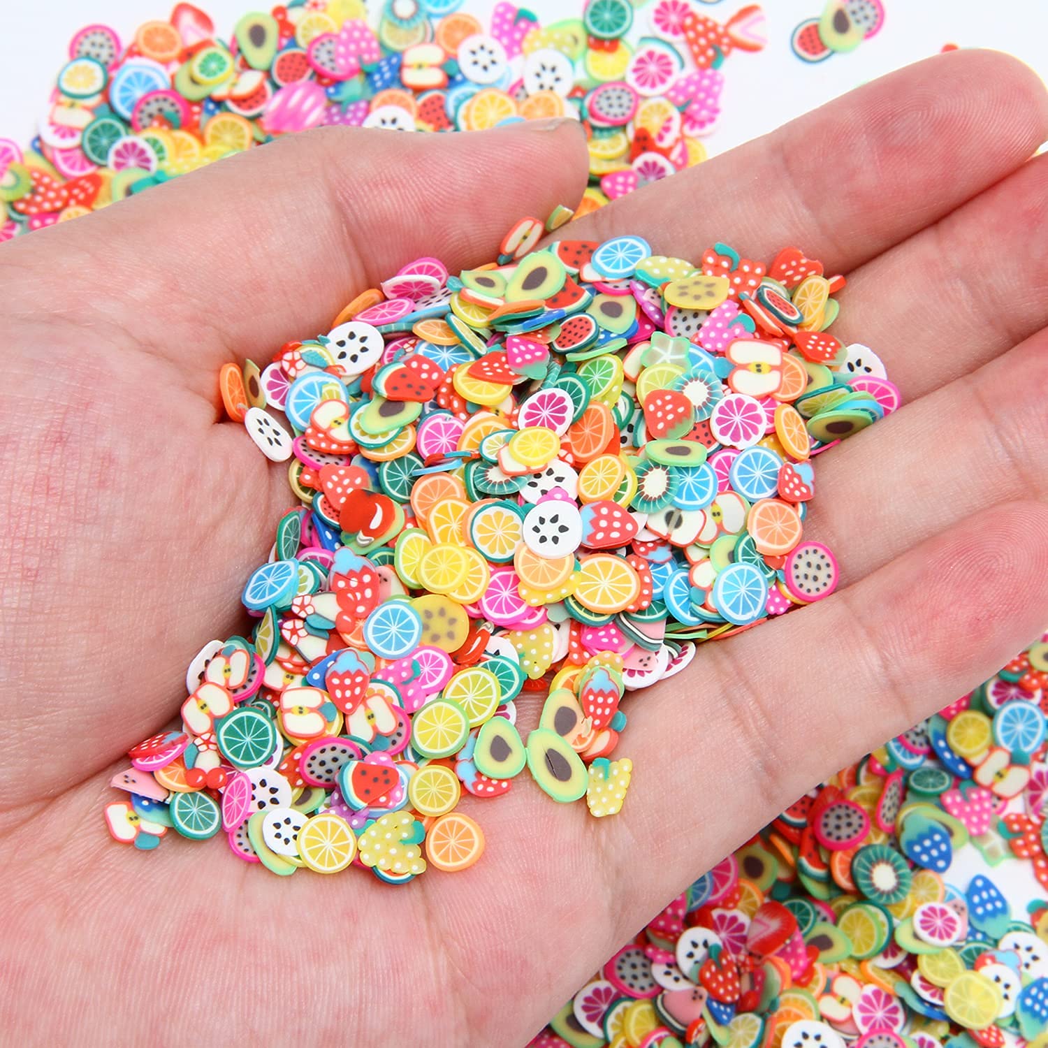 Close up view of miniature clay fruit charms for nail art decorations
