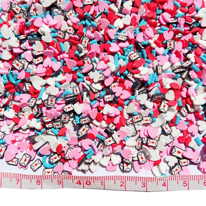 Overhead view of 50 grams package of Valentine themed faux candy sprinkles scattered on a white background