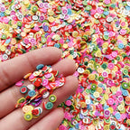 Close up of colorful fruit and flower fimo slices for slime and crafts