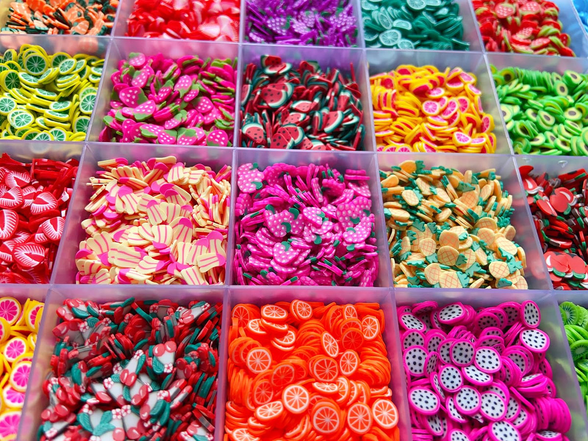 Complete storage organizer grid filled with miniature fruit slices