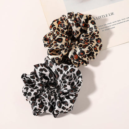 Different angles of the smooth texture on the Ivyu silk satin ponytail holder.