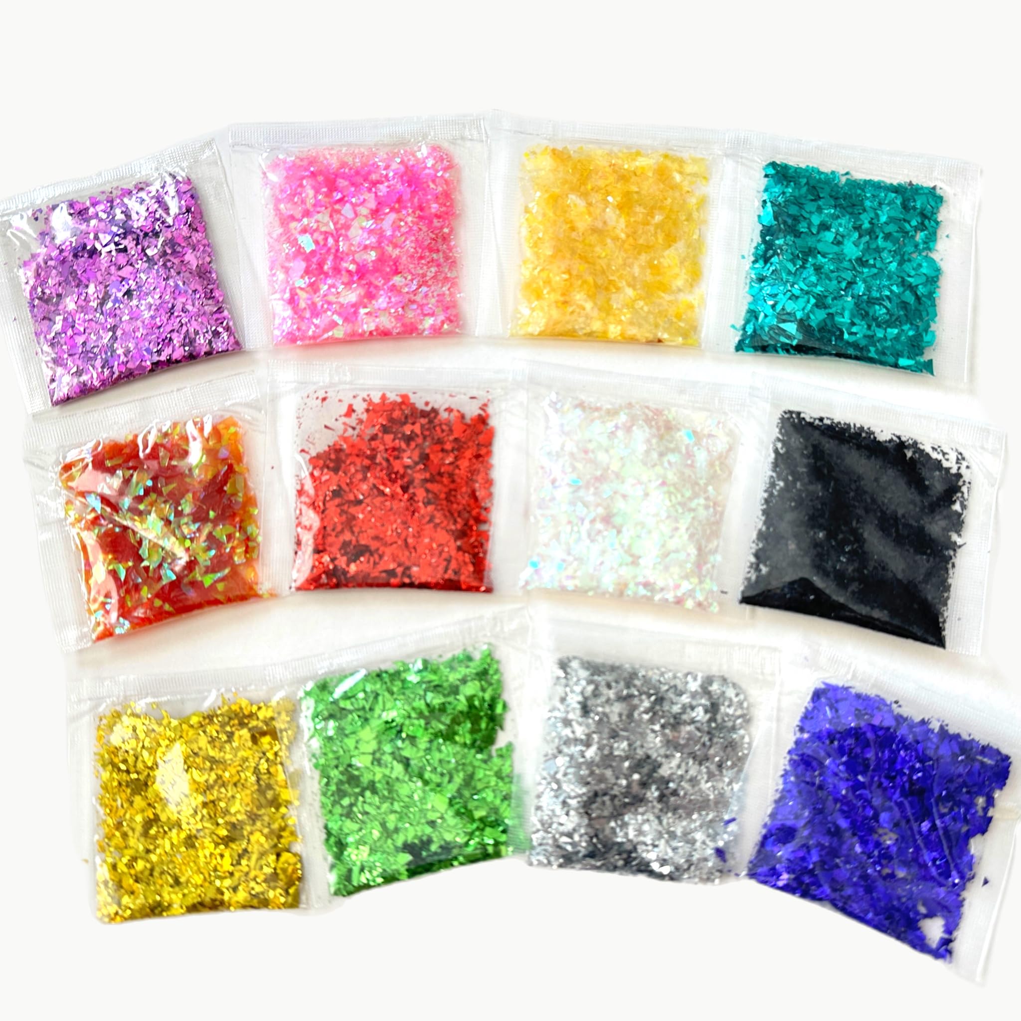 Variety of 12 glitter color packets arranged for craft project
