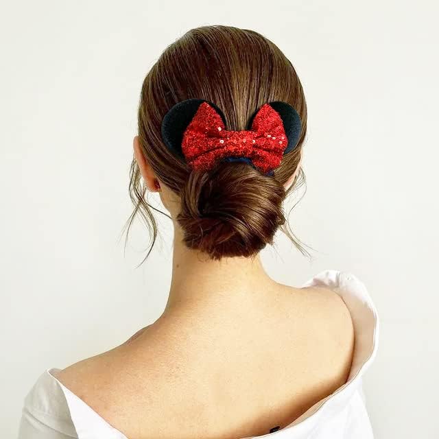 Model wearing a high ponytail held by a Christmas Style black and red sparkle sequin mouse bow hair band.