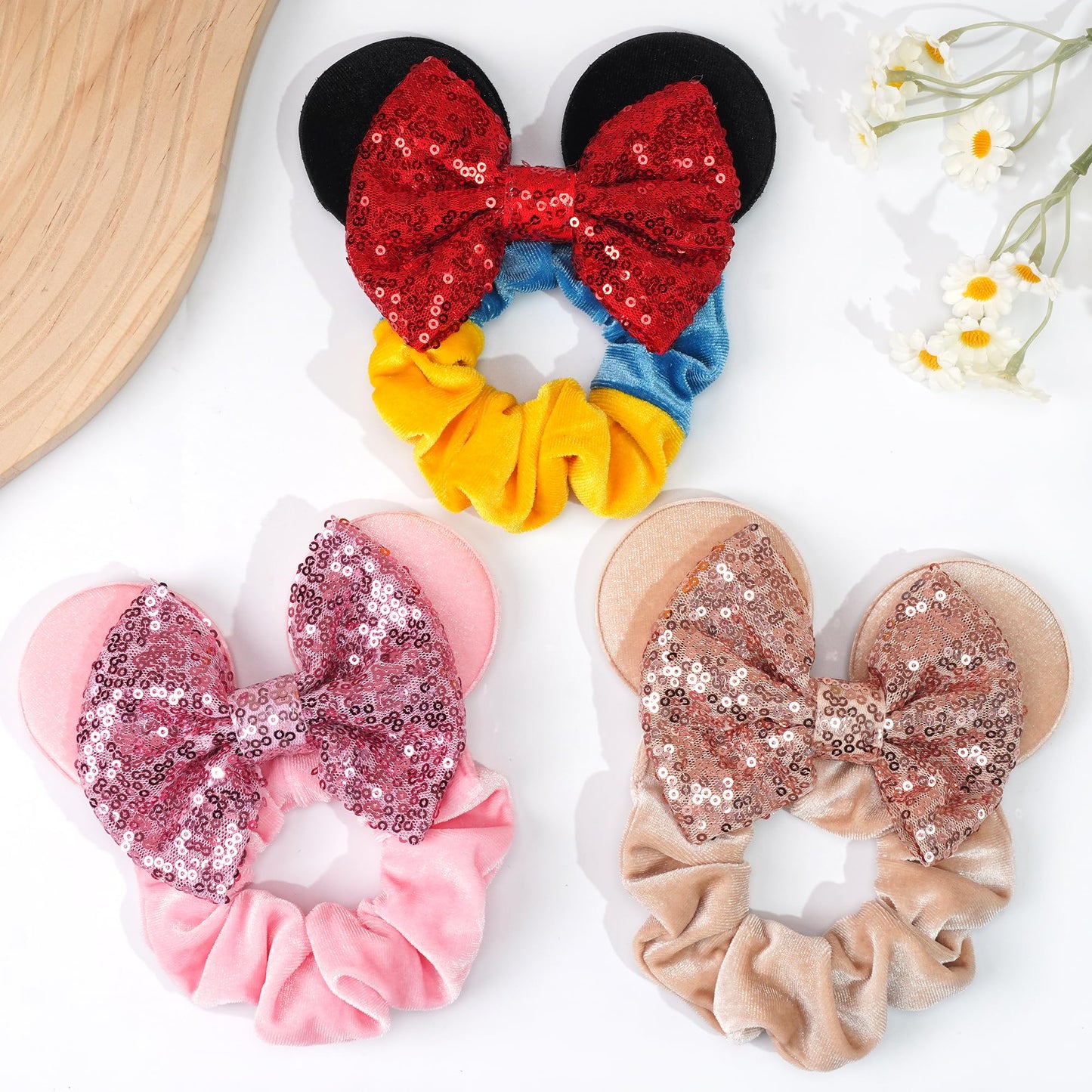Six pack assortment of CellElection cartoon mouse ear elastic ponytail holders laid flat.