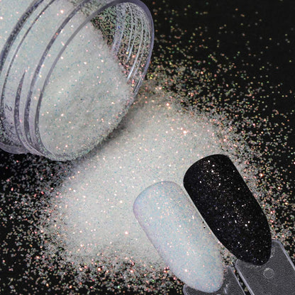 Professional nail technician applying shimmer dust to nails