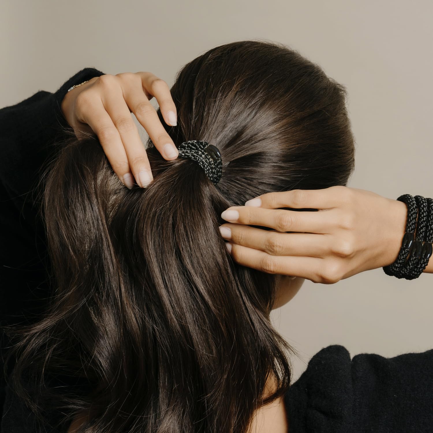 L. Erickson black woven hair ties with metallic tube clasp details.
