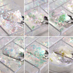 Assorted compartments of shimmering nail art decorations