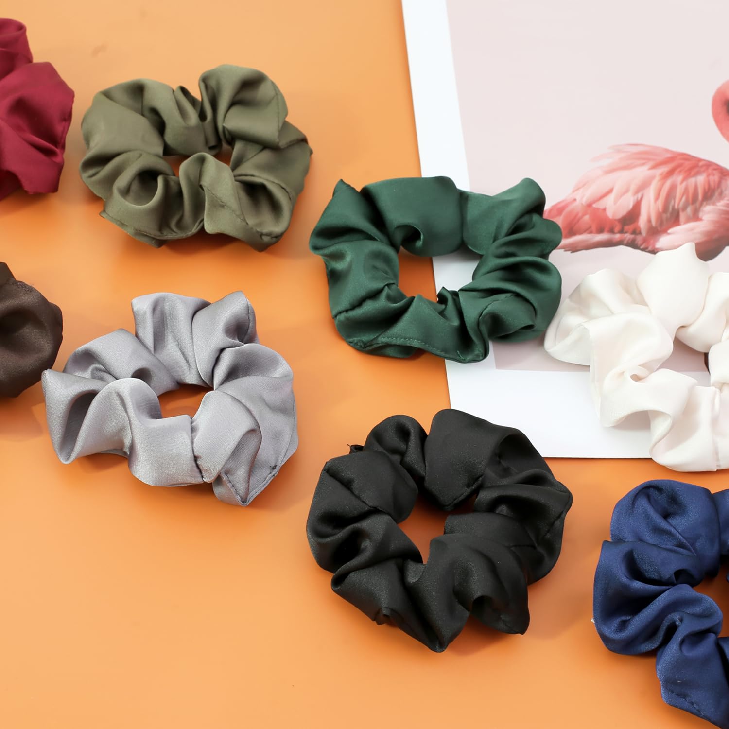 Sixteen pieces of neutral shaded hair accessories arranged neatly by tone