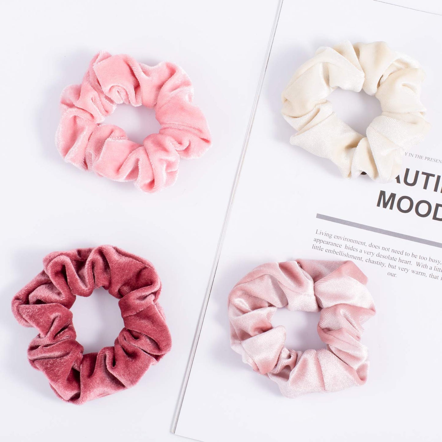 Model with thick curly hair wearing a pink Whaline velvet scrunchie in a high ponytail.
