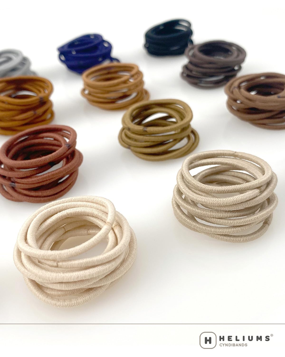 Heliums mini black hair ties being used for a kids multi section ponytail hairstyle