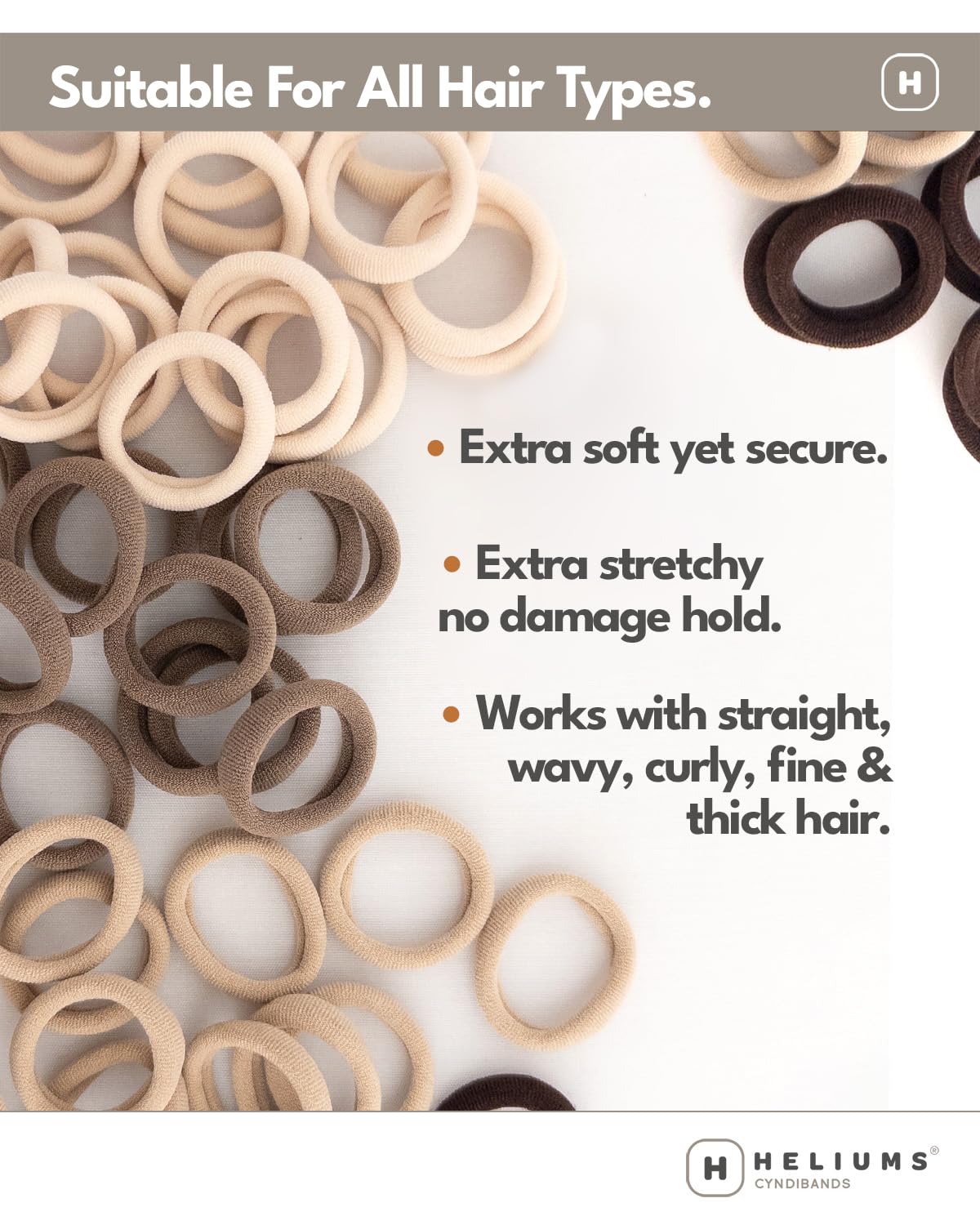 Heliums standard one point five inch ponytail holders being held to display thickness.