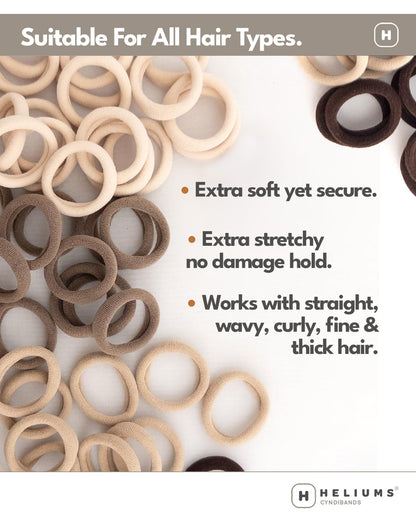 Heliums standard one point five inch ponytail holders being held to display thickness.
